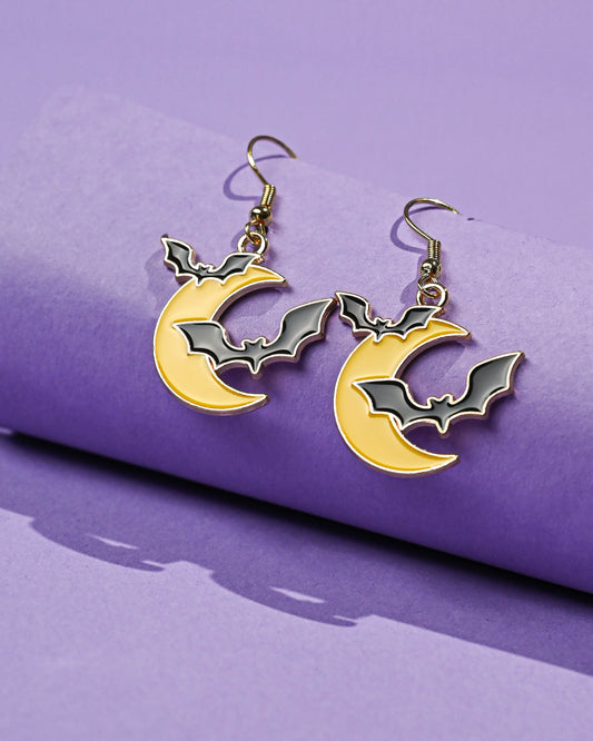 Bats At Moonlight Dangle Earrings with two bats and a golden crescent moon on a purple backdrop.