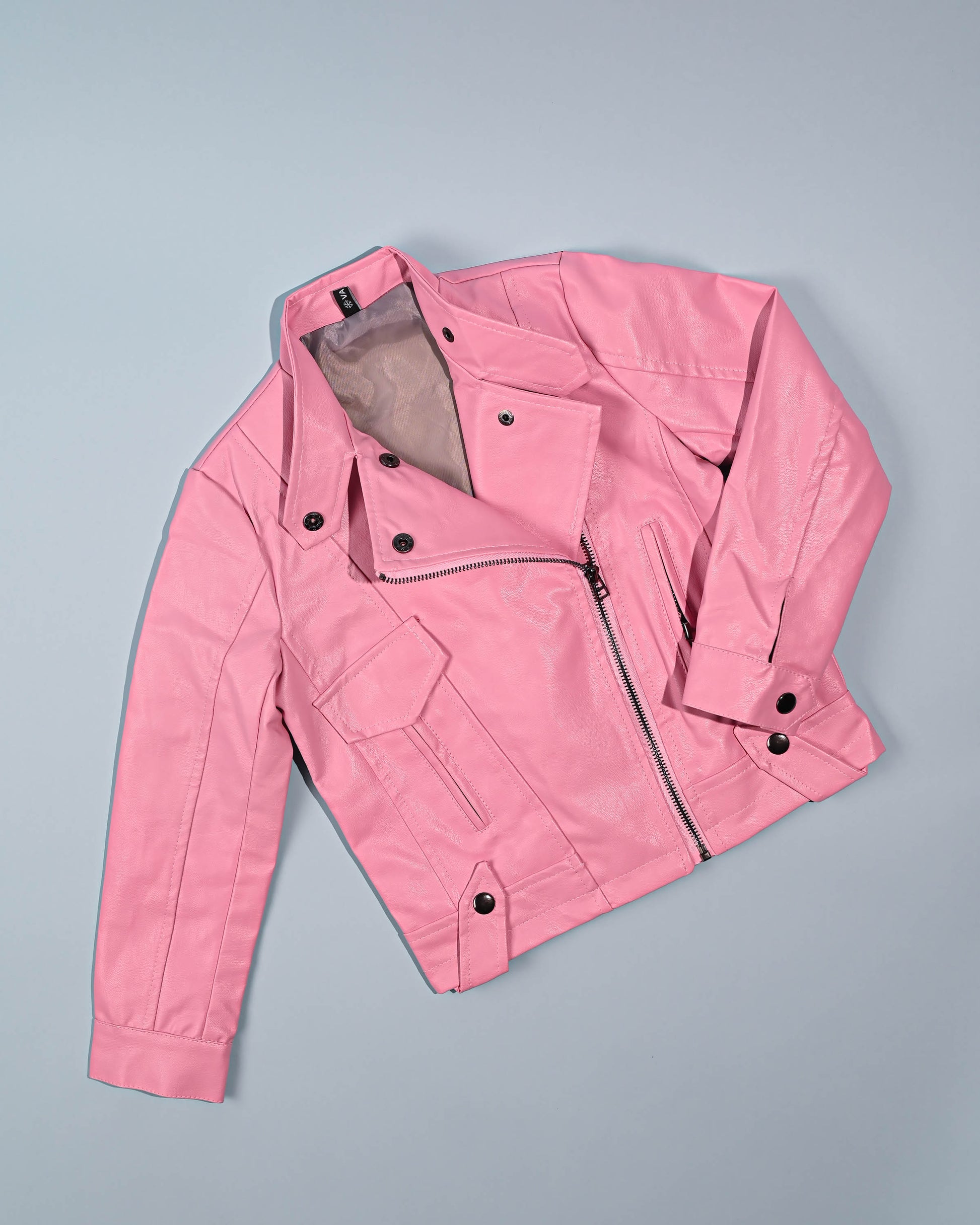 Soft pink leather jacket presented on a grey backdrop, showcasing its stylish zipper and button details.