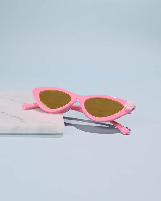 Pink Skull Cat Eye Sunglasses with a vintage flair, displayed on a marble slab for a stylish presentation.