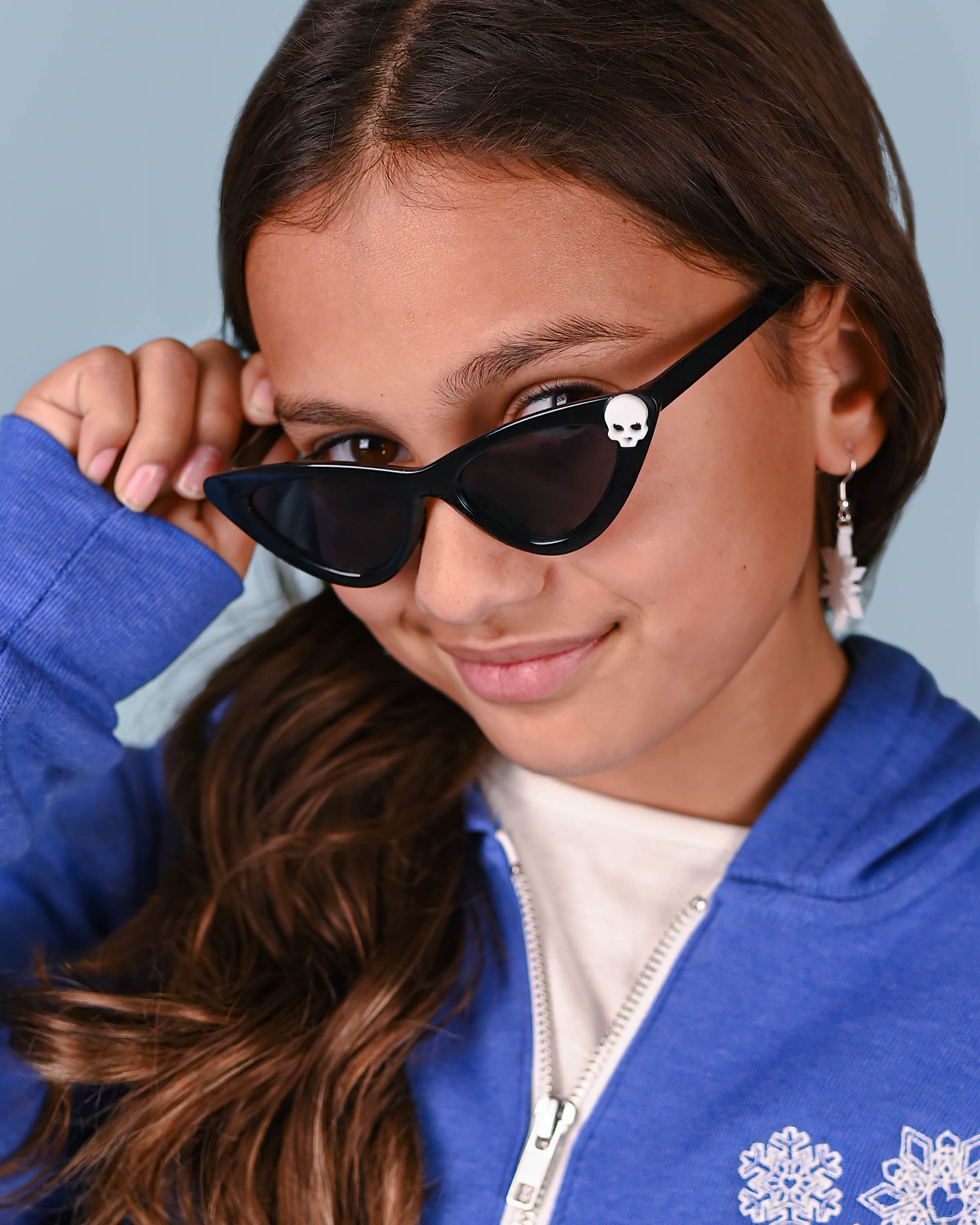 Charming Black Skull Cat Eye Sunglasses worn by a young girl, perfectly paired with a casual outfit for a touch of retro chic.